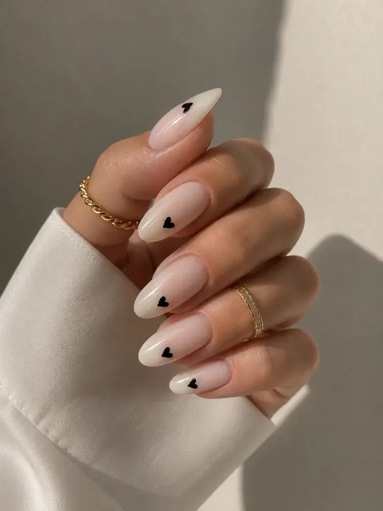 Trendy White Almond Nails with Black Heart Accent - фото 3