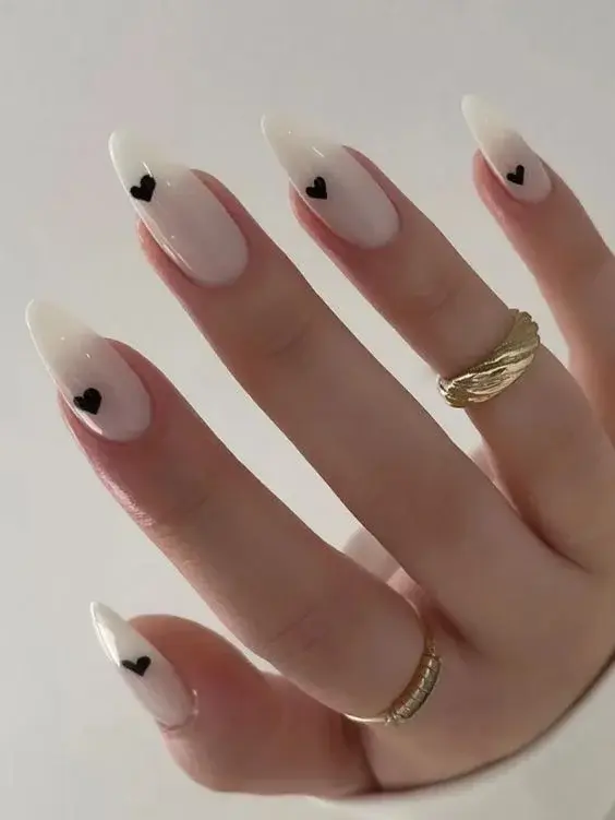 Trendy White Almond Nails with Black Heart Accent - фото 4