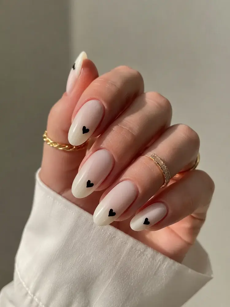 Trendy White Almond Nails with Black Heart Accent - фото 1